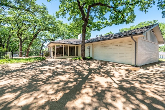 1904 Park Hill Dr, Arlington, TX 76012 - ranch-style home featuring fence, brick siding, driveway, a garage, and a sunroom