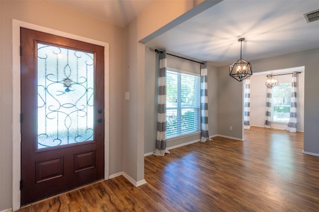 1904 Park Hill Dr, Arlington, TX 76012 - entrance foyer with plenty of natural light, visible vents, wood finished floors, and a notable chandelier