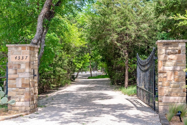 view of road with a gate and a gated entry