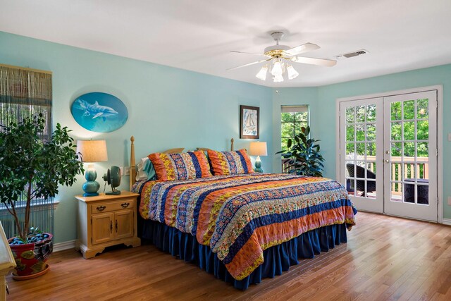 bedroom featuring baseboards, light wood-style flooring, visible vents, and access to outside