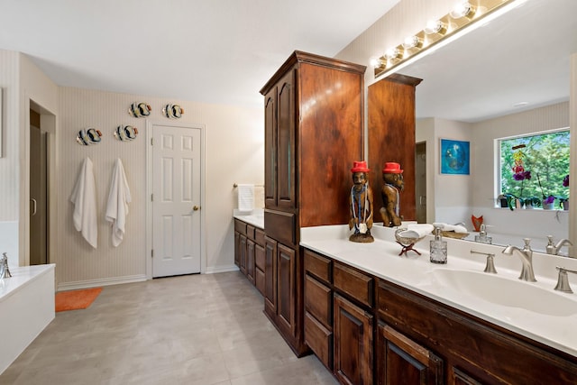 full bathroom featuring a bath, baseboards, and vanity