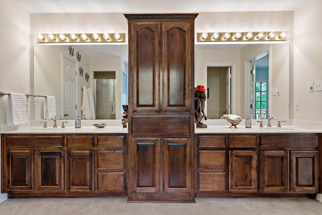 full bath featuring a sink and double vanity