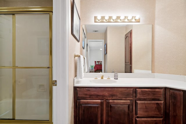 ensuite bathroom featuring vanity, a stall shower, ensuite bathroom, and visible vents