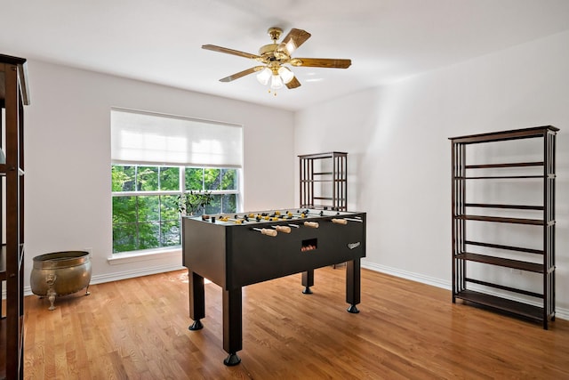 game room with ceiling fan, baseboards, and wood finished floors