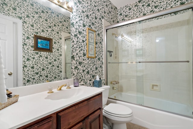 full bath featuring enclosed tub / shower combo, toilet, vanity, and wallpapered walls