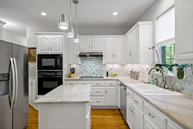 kitchen featuring black appliances, backsplash, white cabinetry, and a sink