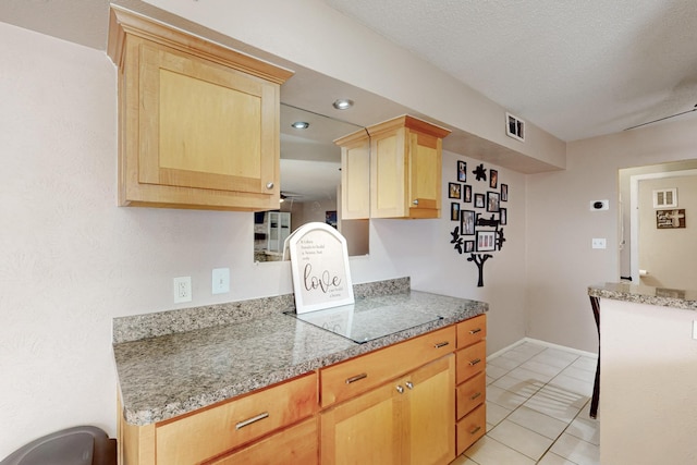kitchen with light brown cabinets, light countertops, baseboards, visible vents, and recessed lighting