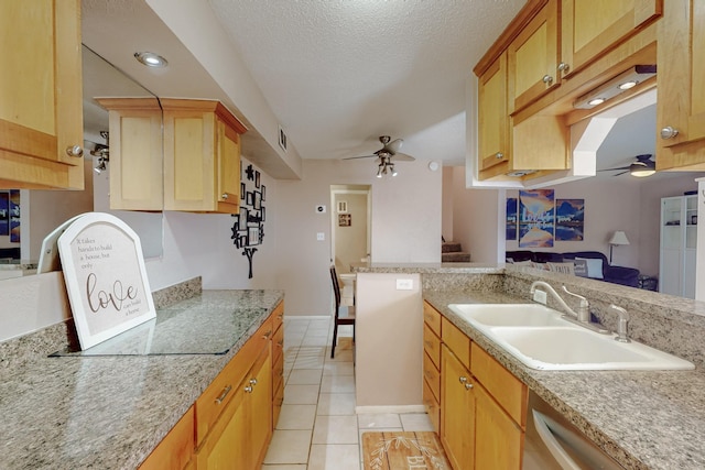 kitchen with a sink, a textured ceiling, visible vents, ceiling fan, and light tile patterned floors