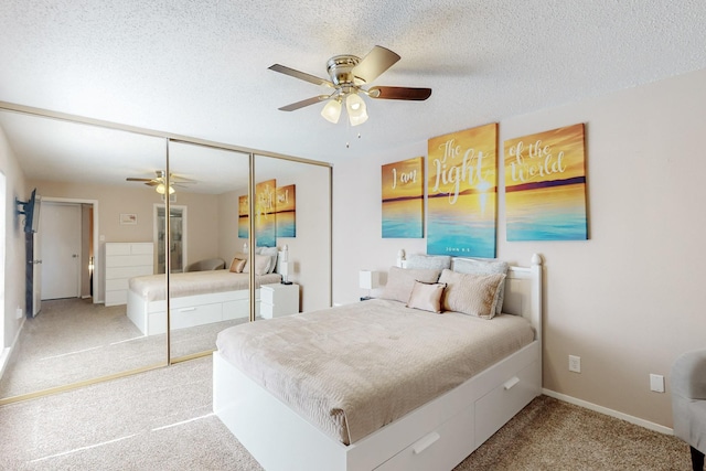 bedroom featuring a textured ceiling, baseboards, a ceiling fan, a closet, and carpet floors