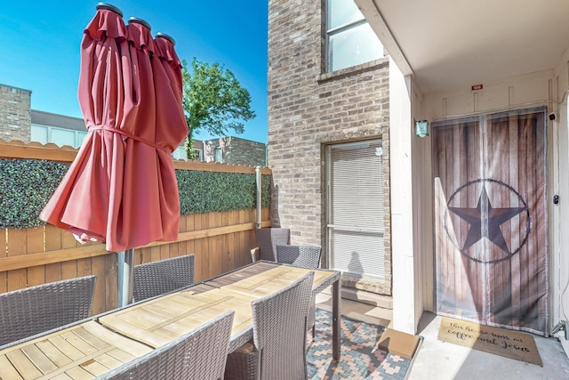 view of patio featuring fence and outdoor dining space