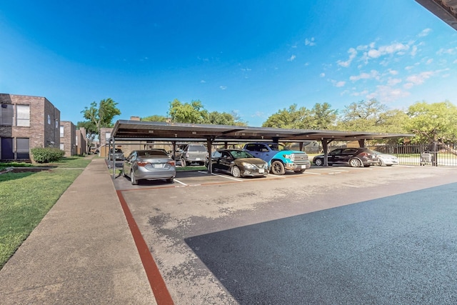 covered parking lot featuring fence