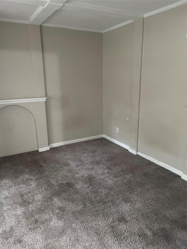 unfurnished living room featuring baseboards, carpet flooring, and ornamental molding