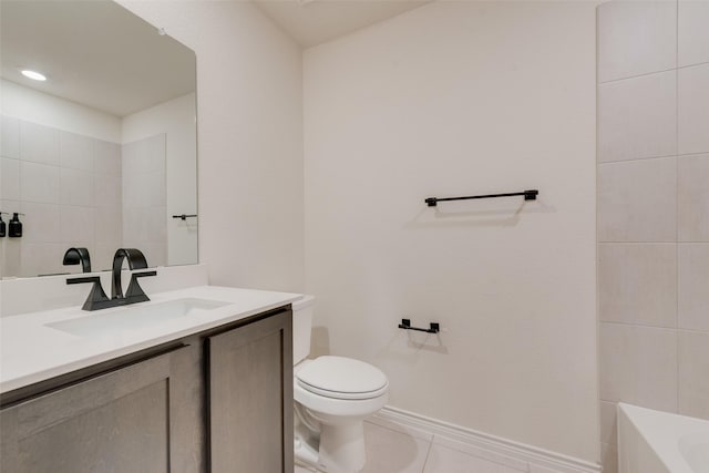 bathroom with vanity, a bathtub, toilet, baseboards, and tile patterned flooring