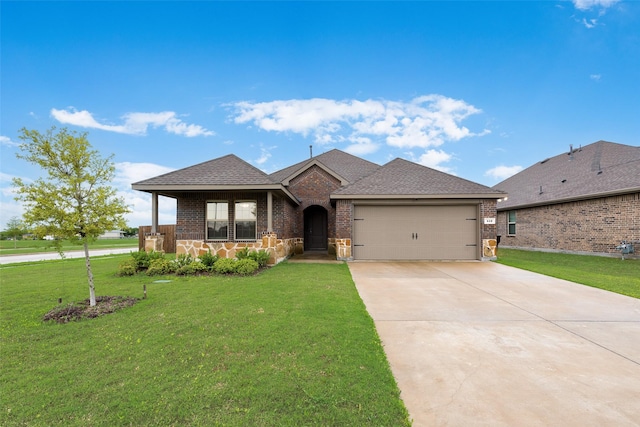 ranch-style home with brick siding, roof with shingles, a front yard, concrete driveway, and an attached garage