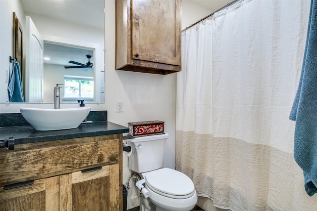 full bathroom featuring toilet, vanity, and a ceiling fan