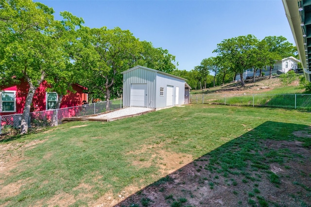 view of yard with an outbuilding, a garage, and a fenced backyard