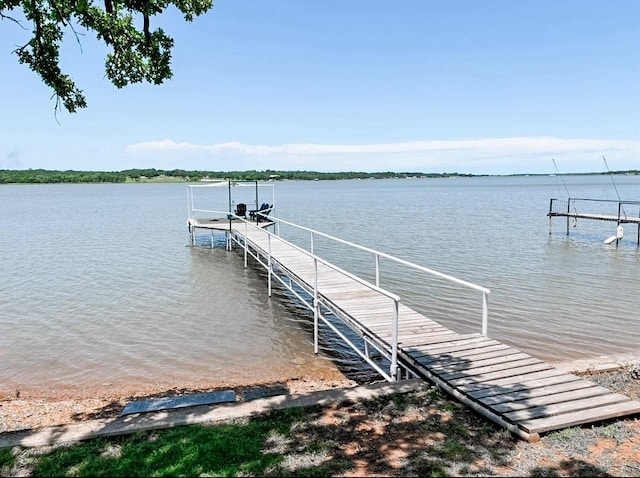 view of dock with boat lift and a water view
