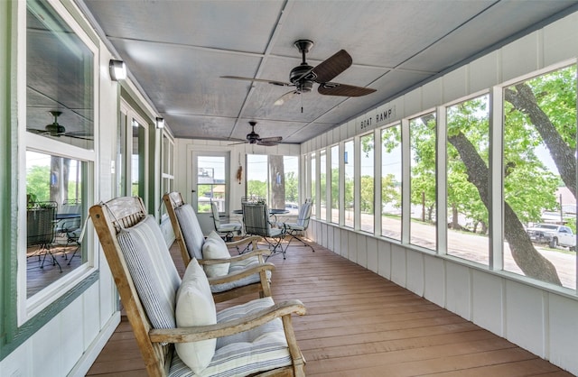 sunroom / solarium featuring a wealth of natural light and ceiling fan