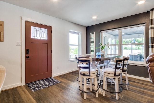 foyer entrance featuring dark wood-style flooring, baseboards, and recessed lighting