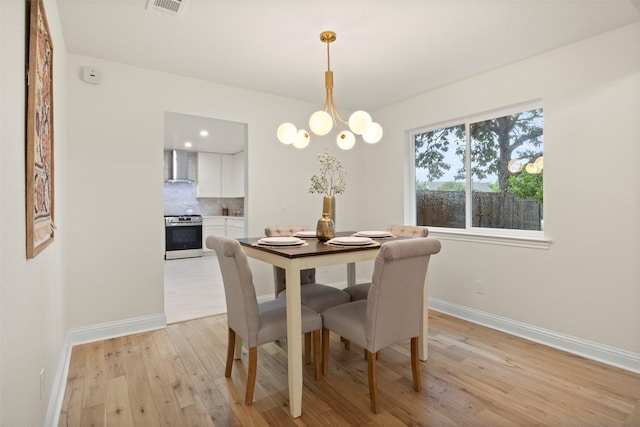 1925 Berkner Dr, Richardson, TX 75081 - dining area with light wood-type flooring, baseboards, and a chandelier