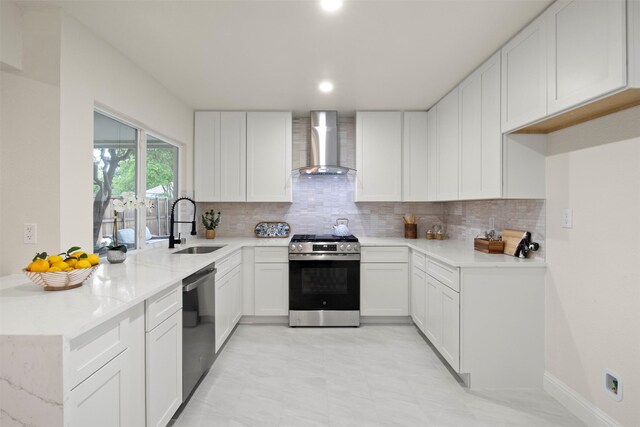 1925 Berkner Dr, Richardson, TX 75081 - kitchen featuring wall chimney range hood, appliances with stainless steel finishes, a sink, decorative backsplash, and recessed lighting