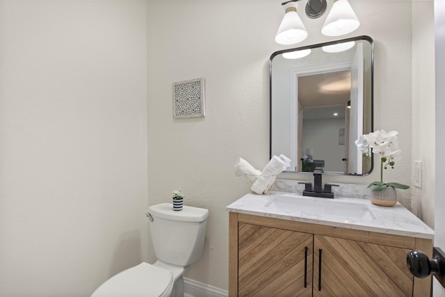 1925 Berkner Dr, Richardson, TX 75081 - bathroom featuring toilet, vanity, and baseboards