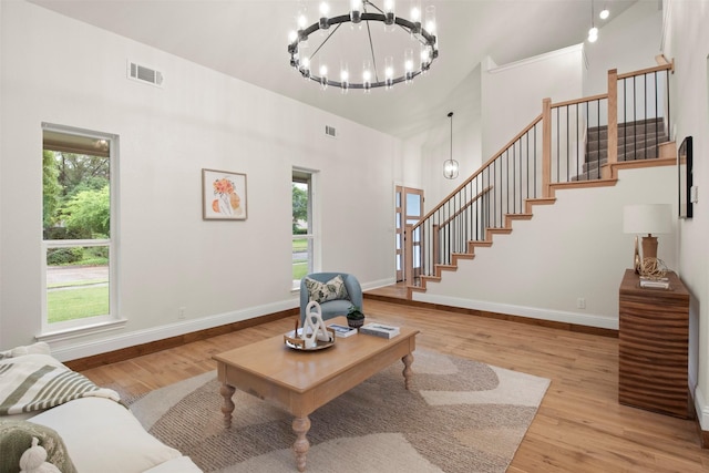 1925 Berkner Dr, Richardson, TX 75081 - living room with stairway, wood finished floors, a towering ceiling, and baseboards