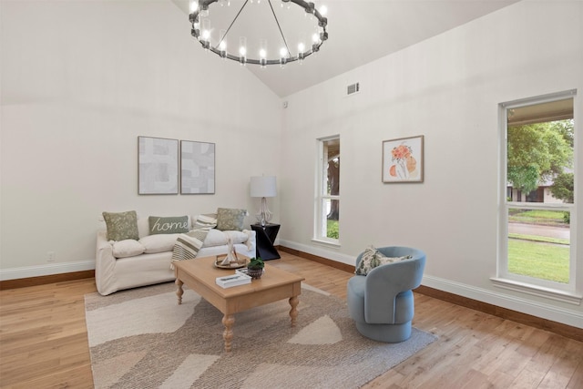 1925 Berkner Dr, Richardson, TX 75081 - living area featuring plenty of natural light, baseboards, a chandelier, and high vaulted ceiling