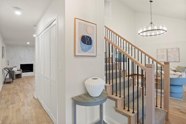 1925 Berkner Dr, Richardson, TX 75081 - stairway with a chandelier, wood finished floors, a fireplace, and recessed lighting