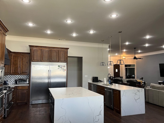 251 Rs County Road 3430, Emory, TX 75440 - kitchen with crown molding, a sink, open floor plan, stainless steel appliances, and a kitchen island