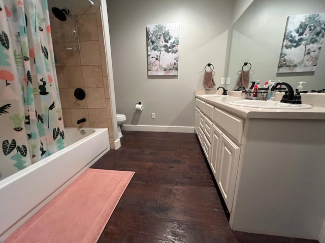 251 Rs County Road 3430, Emory, TX 75440 - full bathroom with wood finished floors, toilet, a sink, shower / bath combo with shower curtain, and baseboards
