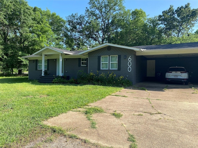 600 Bunny Rabbit Rd N, Athens, TX 75751 - ranch-style home featuring concrete driveway, a front lawn, an attached carport, and brick siding