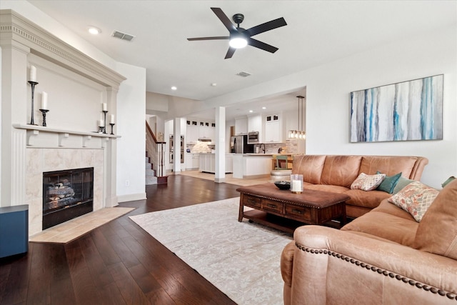 3852 Banner Dr, Frisco, TX 75034 - living room with ceiling fan, stairs, a fireplace, and dark wood-style floors