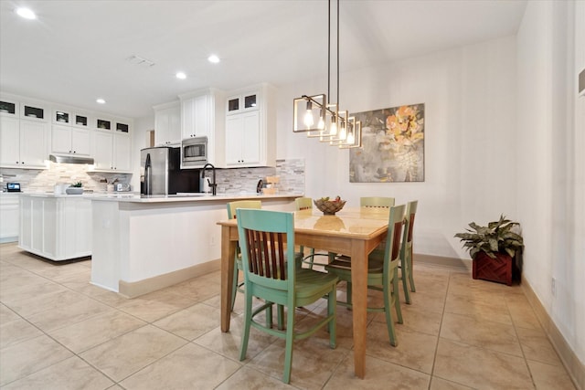 3852 Banner Dr, Frisco, TX 75034 - dining area with light tile patterned floors and recessed lighting