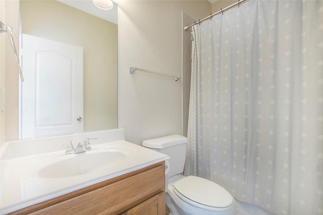 full bath featuring toilet, vanity, and curtained shower