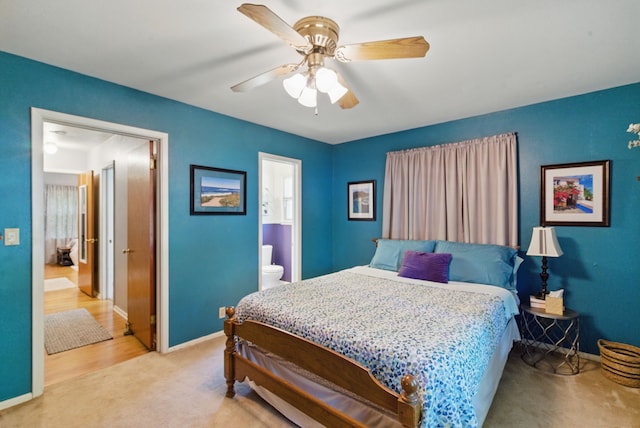bedroom featuring connected bathroom, a ceiling fan, baseboards, and light colored carpet