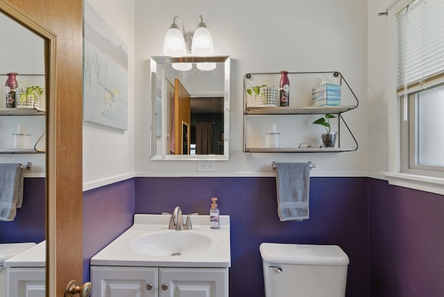 bathroom featuring toilet and vanity