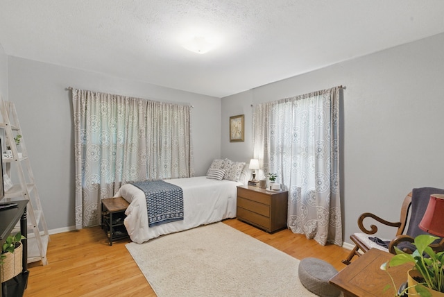 bedroom featuring light wood-style flooring and baseboards