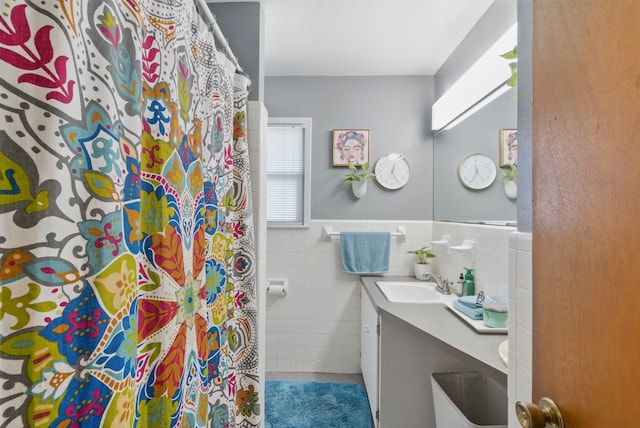 6050 Douglas St, Fort Worth, TX 76114 - full bathroom with vanity, tile walls, wainscoting, a shower with curtain, and tile patterned floors