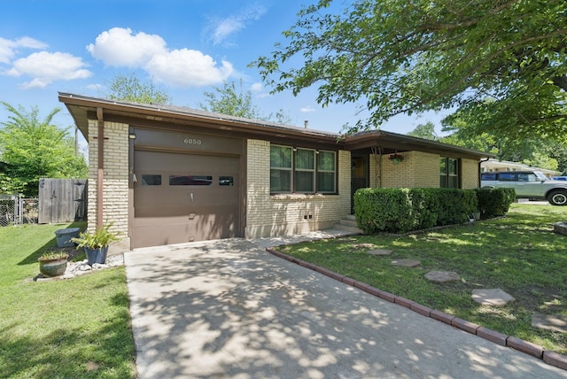 view of front of home featuring a garage, a front lawn, brick siding, and concrete driveway