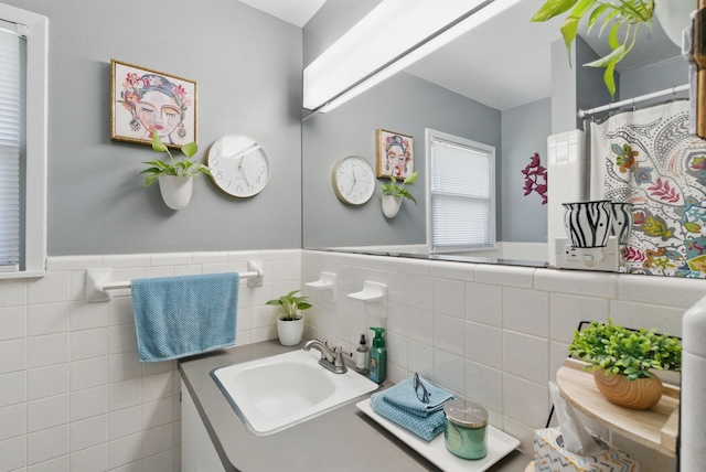 6050 Douglas St, Fort Worth, TX 76114 - full bathroom featuring vanity, wainscoting, and tile walls