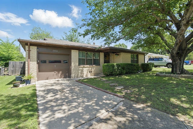 view of front of house featuring an attached garage, driveway, brick siding, and a front yard