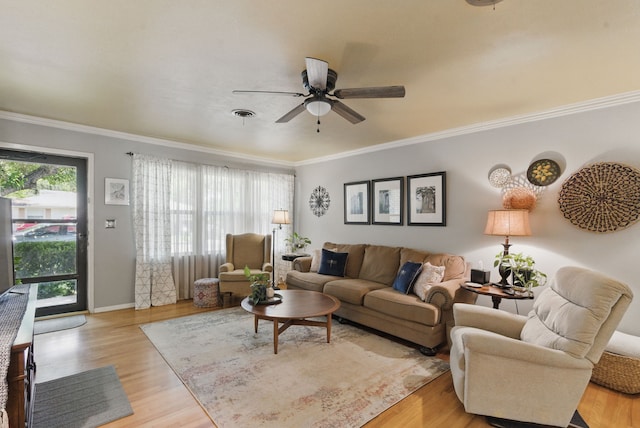 living room with ceiling fan, ornamental molding, and light wood-style floors
