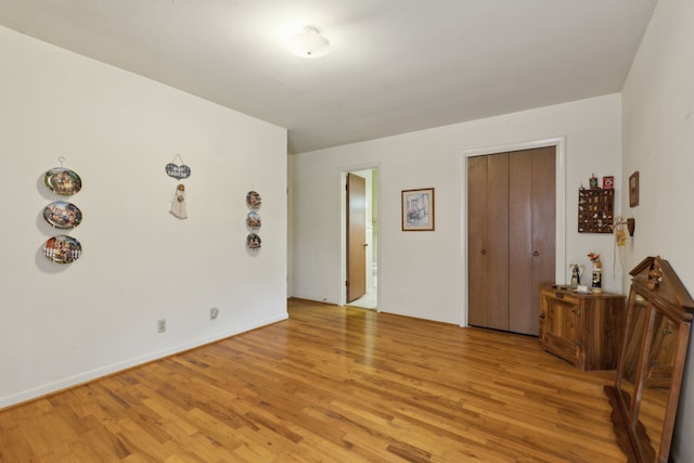 interior space featuring light wood finished floors and baseboards