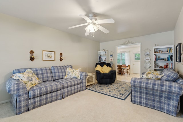 carpeted living room featuring a ceiling fan