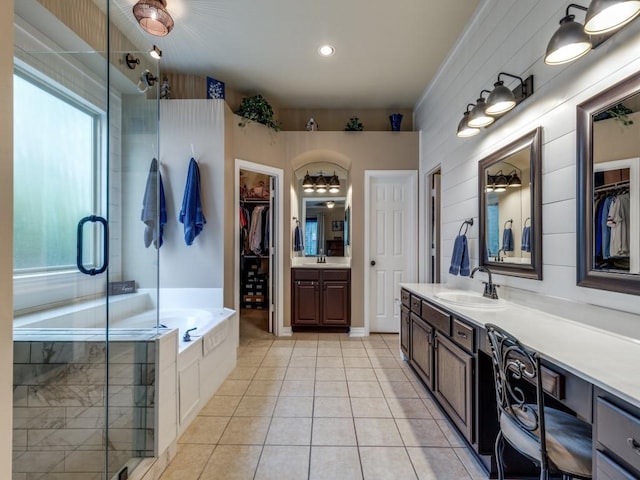 3226 Appleblossom Dr, Frisco, TX 75033 - full bathroom featuring tile patterned floors, two vanities, a garden tub, and a walk in closet
