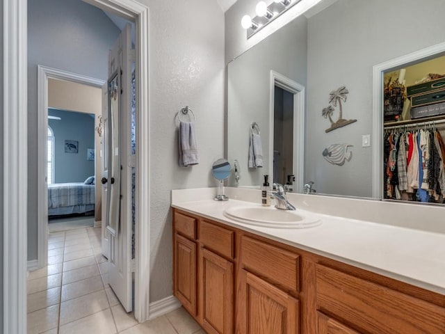 3226 Appleblossom Dr, Frisco, TX 75033 - ensuite bathroom with tile patterned flooring, vanity, baseboards, and a spacious closet