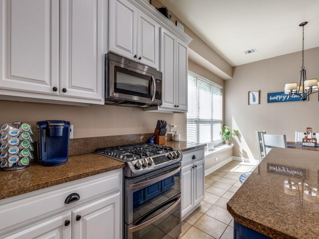 3226 Appleblossom Dr, Frisco, TX 75033 - kitchen with appliances with stainless steel finishes, a chandelier, white cabinets, and light tile patterned floors