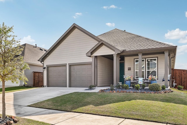 view of front facade with fence, a shingled roof, a front lawn, concrete driveway, and a porch