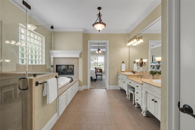 full bath with a tile fireplace, a shower stall, double vanity, a bath, and a sink